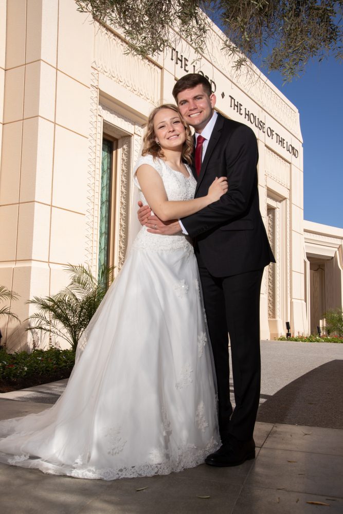 Bride and groom at front entrance to the Gilbert Temple