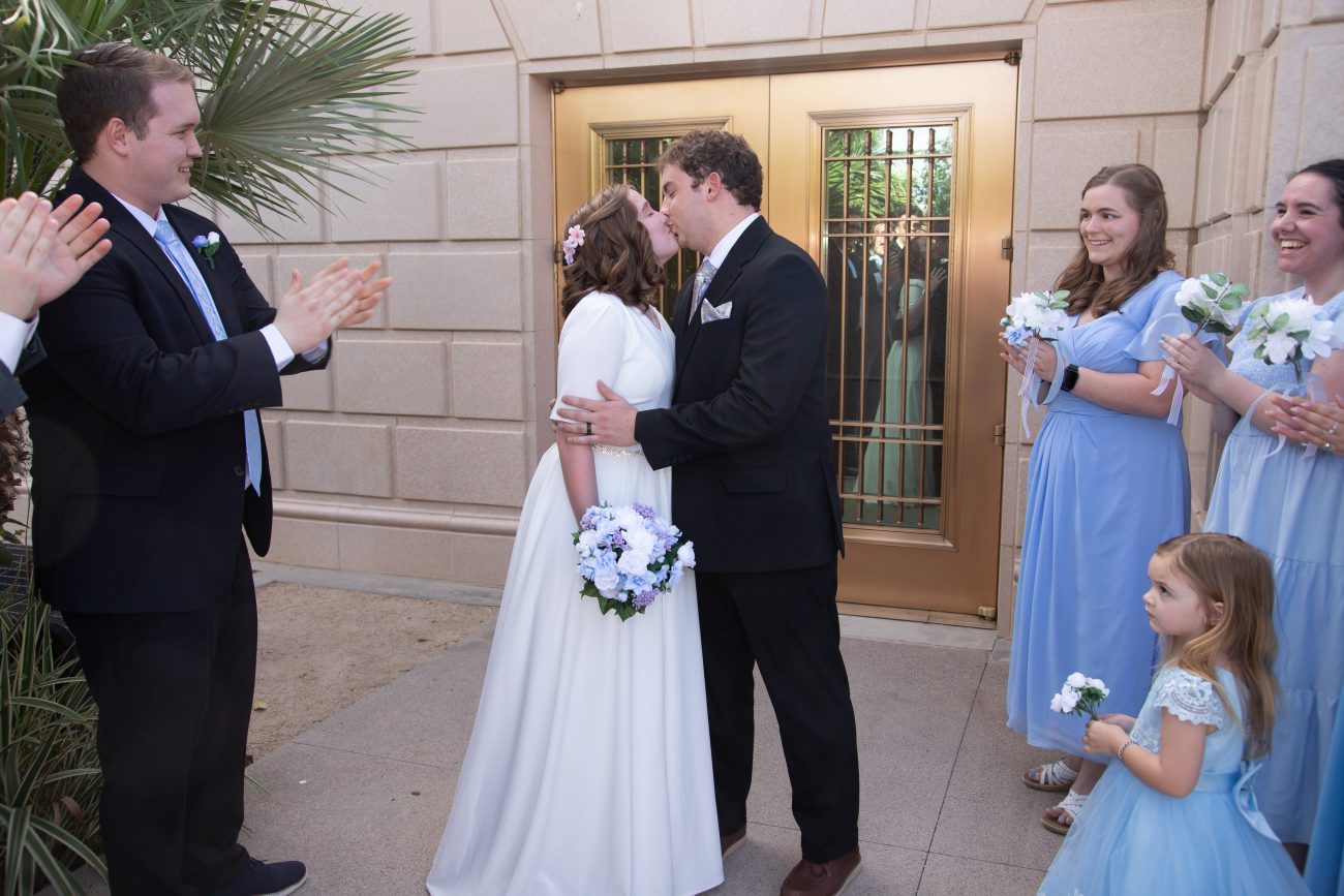 Bride and groom share a first kiss upon exiting the Mesa Arizona Temple
