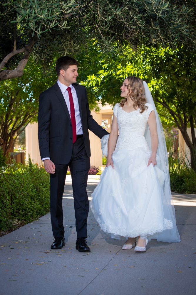 Bride and groom walking at the Gilbert Temple