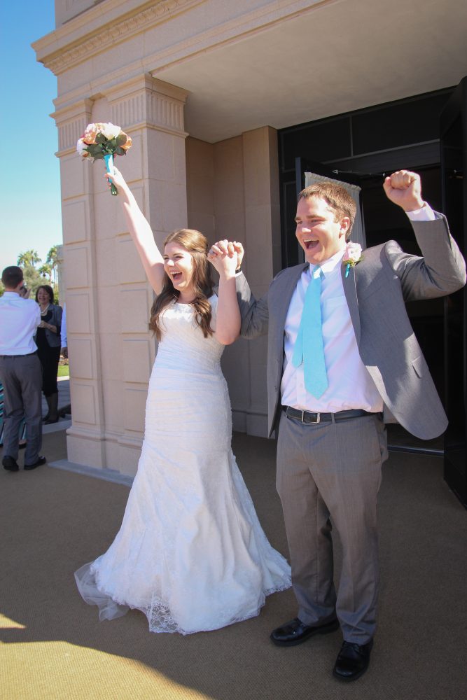 Bride and groom exit the Mesa Arizona Temple after the wedding