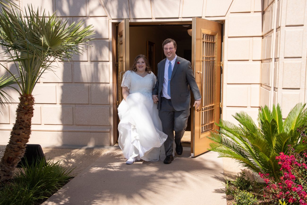 Bride and groom exit the Mesa Arizona Temple after the wedding.