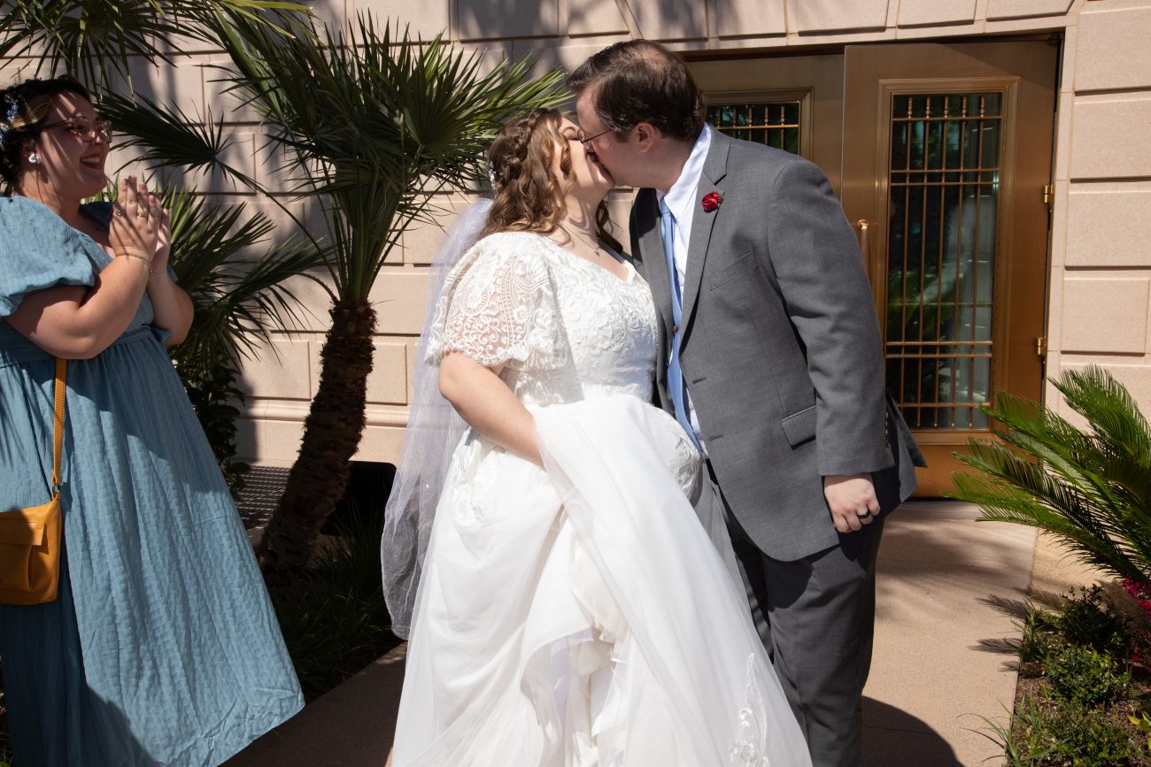 Bride and groom share a first kiss after the wedding at the Mesa Arizona Temple.