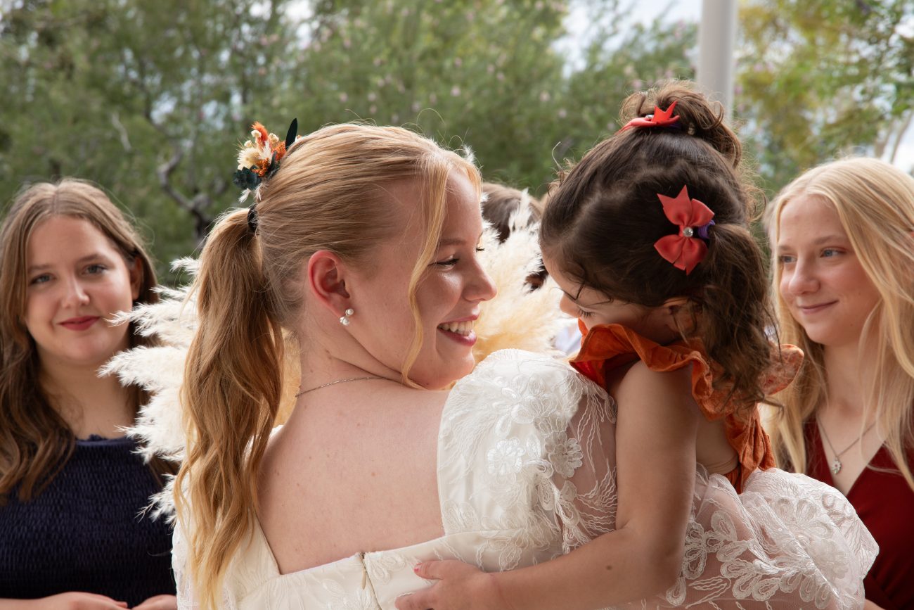 Bride hugging the flower girl after the wedding at the Phoenix Arizona Temple.