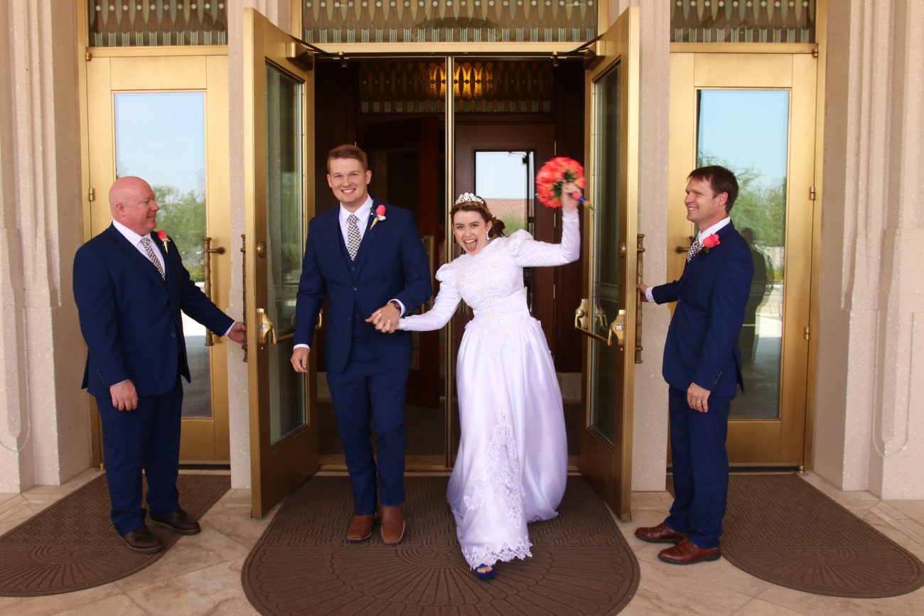 Bride and groom exit the Phoenix Arizona Temple after the wedding.