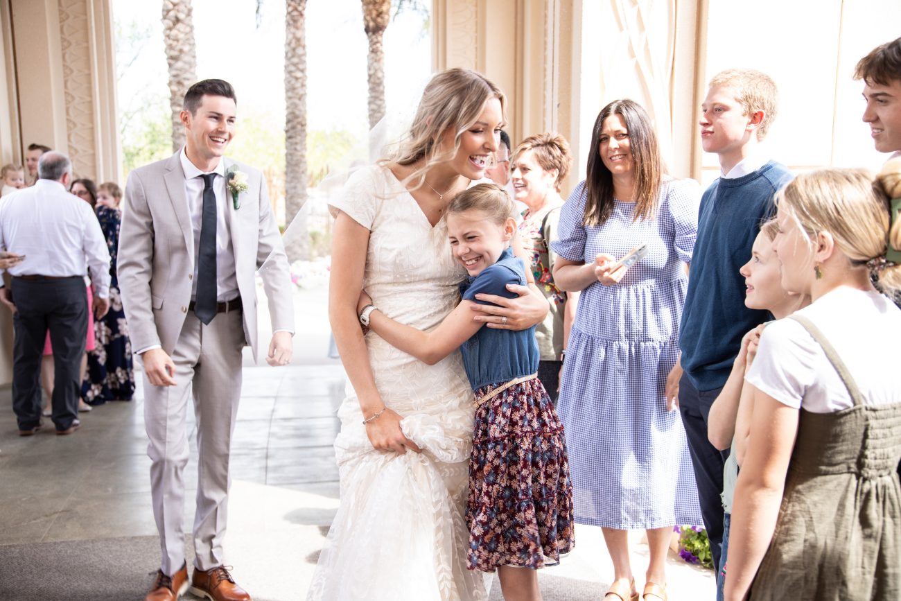 Bride hugging little sister after the wedding at the Gilbert Arizona Temple.