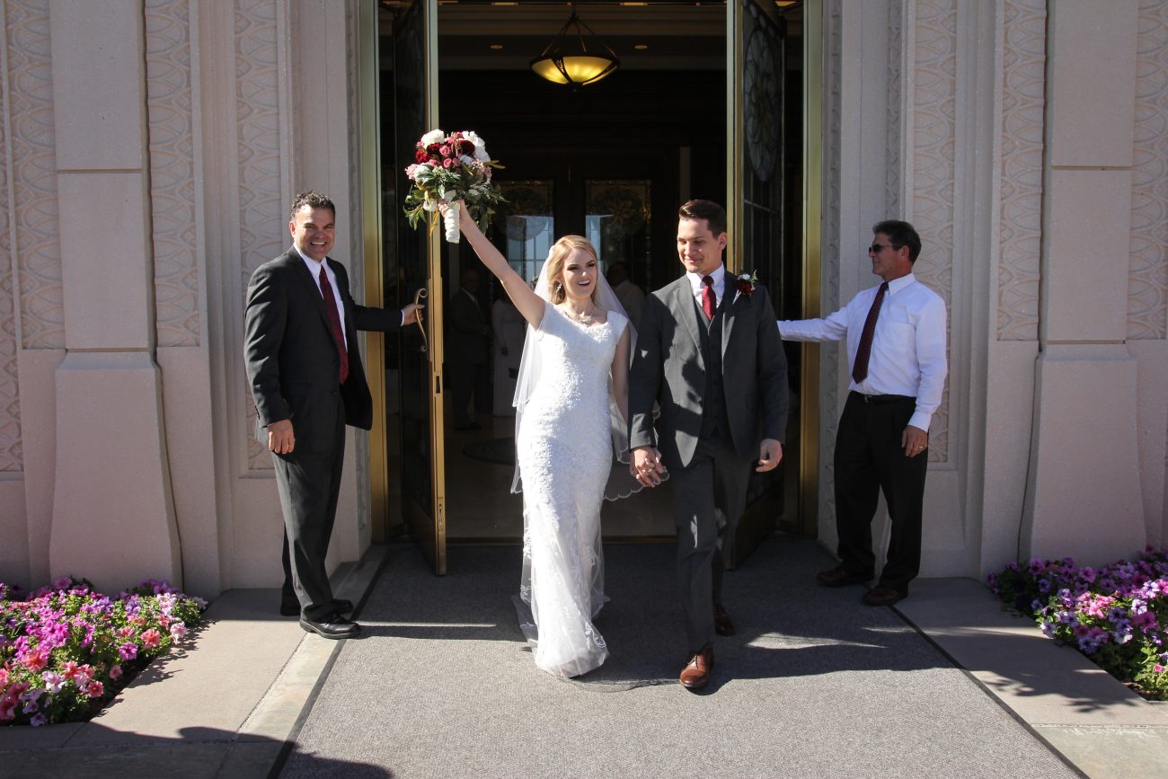 Emma and Kyler, bride and groom exit the Gilbert Temple after the sealing.