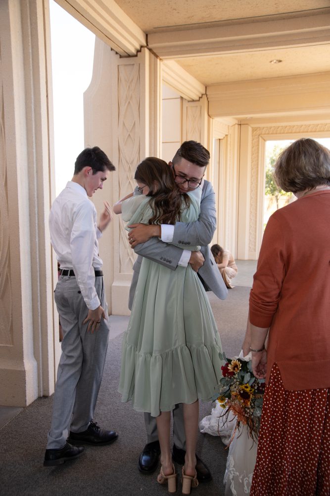 Groom hugging sister after wedding at the Gilbert Arizona Temple.