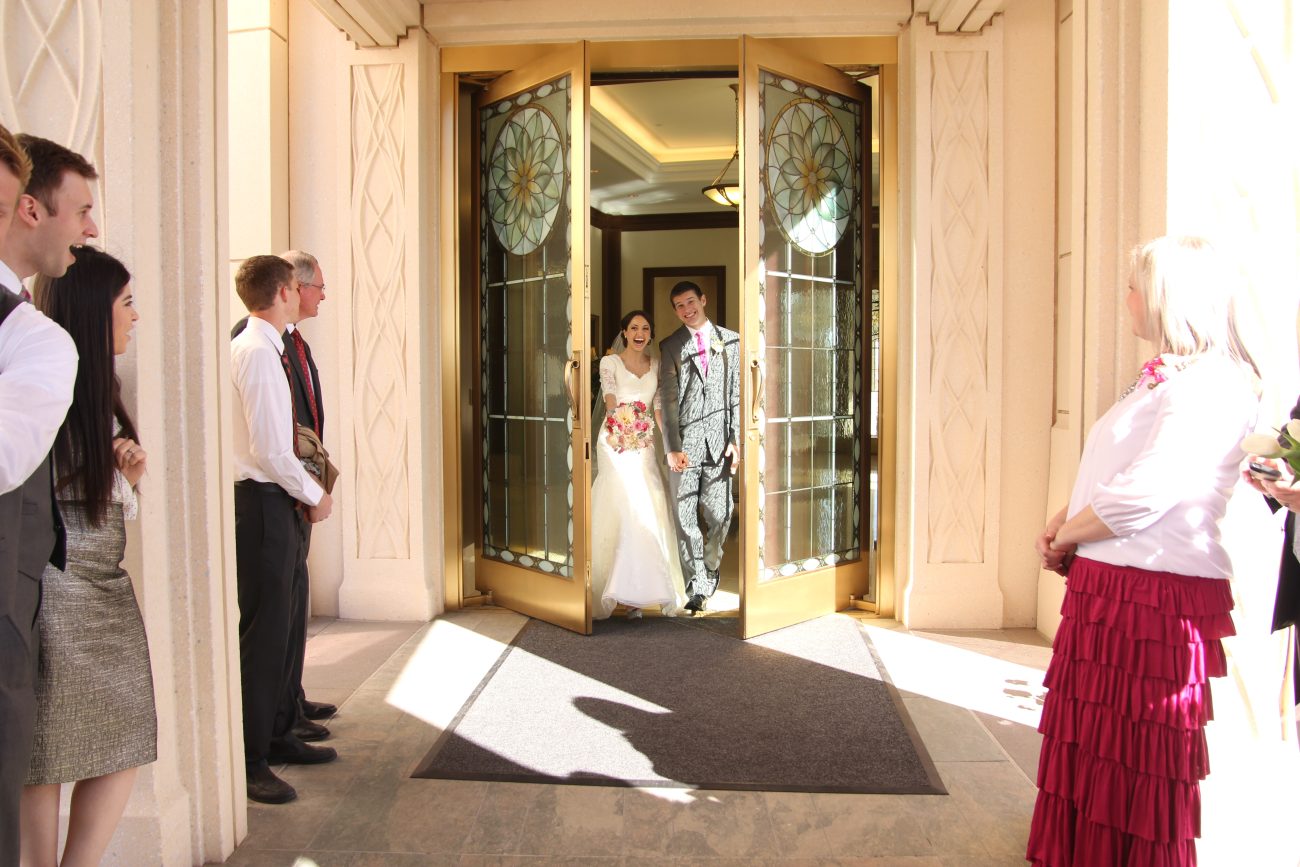 Bride and groom exiting the Gilbert Arizona Temple after the wedding
