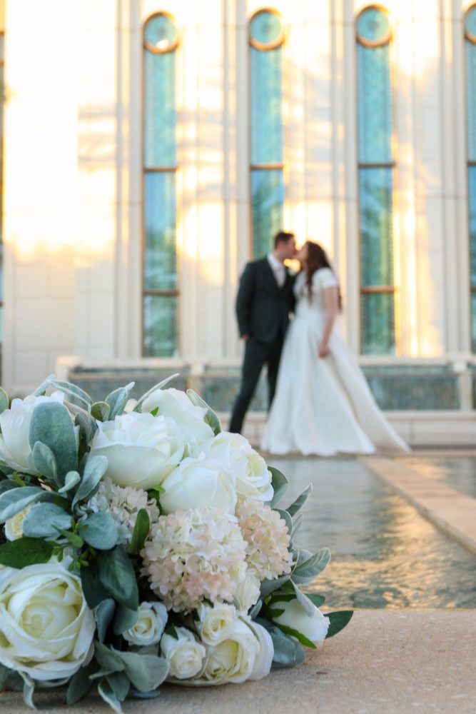 Bride and groom kissing at the waterfall at the Gilbert Arizona Temple