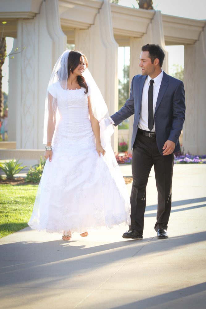 Bride and groom walking closely at the Gilbert Arizona Temple.