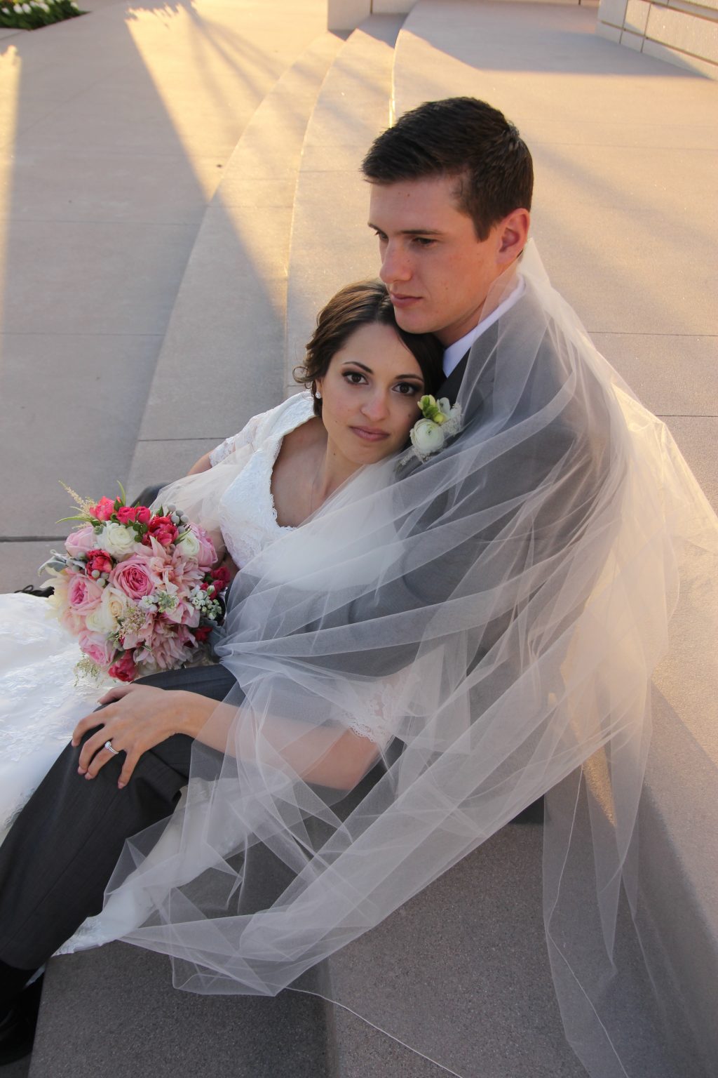Gilbert Temple Wedding photos with bride and groom with veil wrapped around the couple