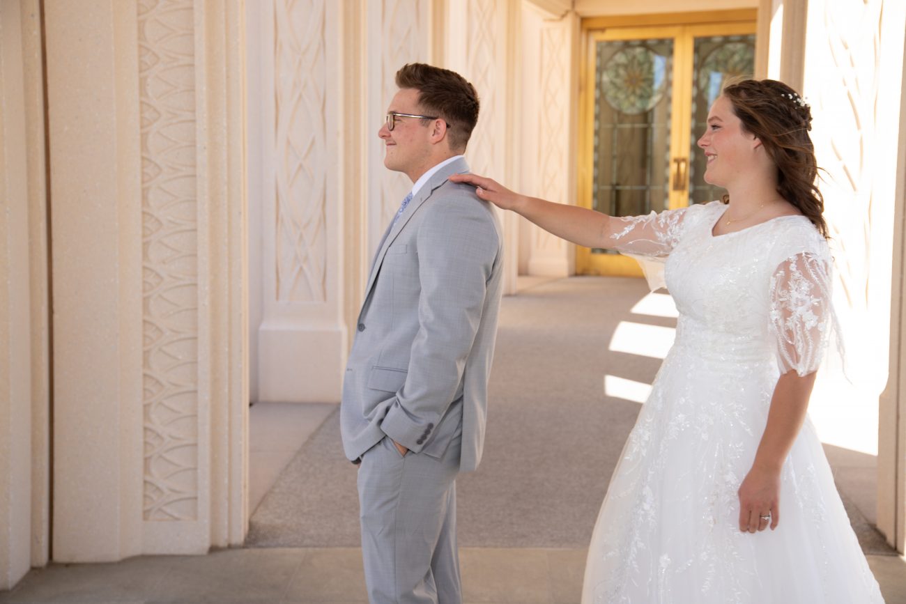 Gilbert Temple Wedding Photography. First look at the Gilbert Temple. Bride tapping groom on shoulder.