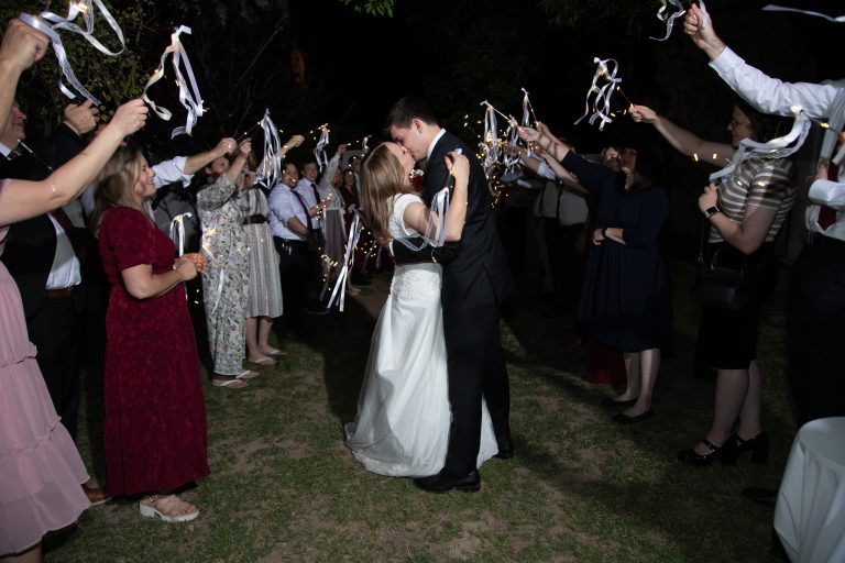 Gilbert Temple wedding couple kissing during their exit from their reception