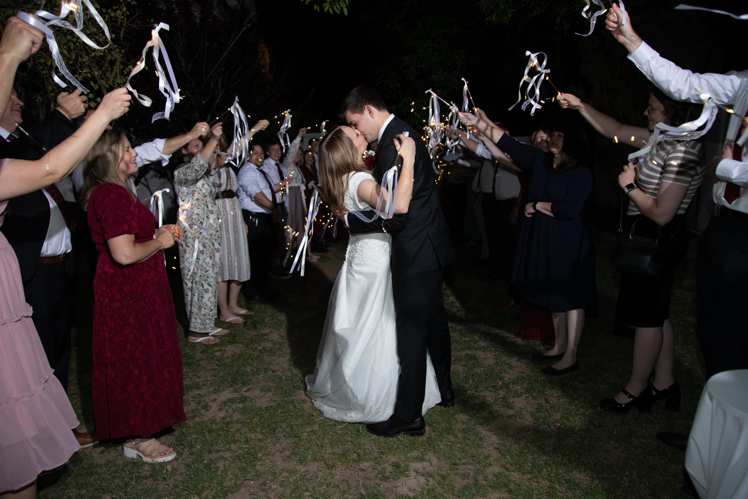 Gilbert Temple wedding couple kissing during their exit from their reception